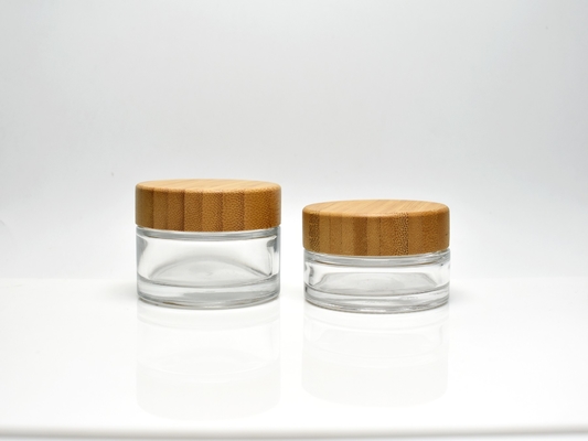 China Sustainable classic 1OZ 1.7OZ Clear or Frosted Glass Cosmetic Jar With Real Bamboo Cap Lid for skincare Face Cream supplier