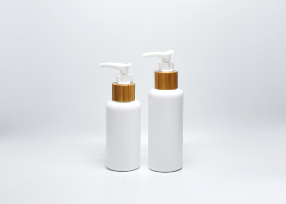China 3.3OZ 4OZ boston round opal white glass bottles with real bamboo-plastic lotion pump, skincare packaging wholesale supplier